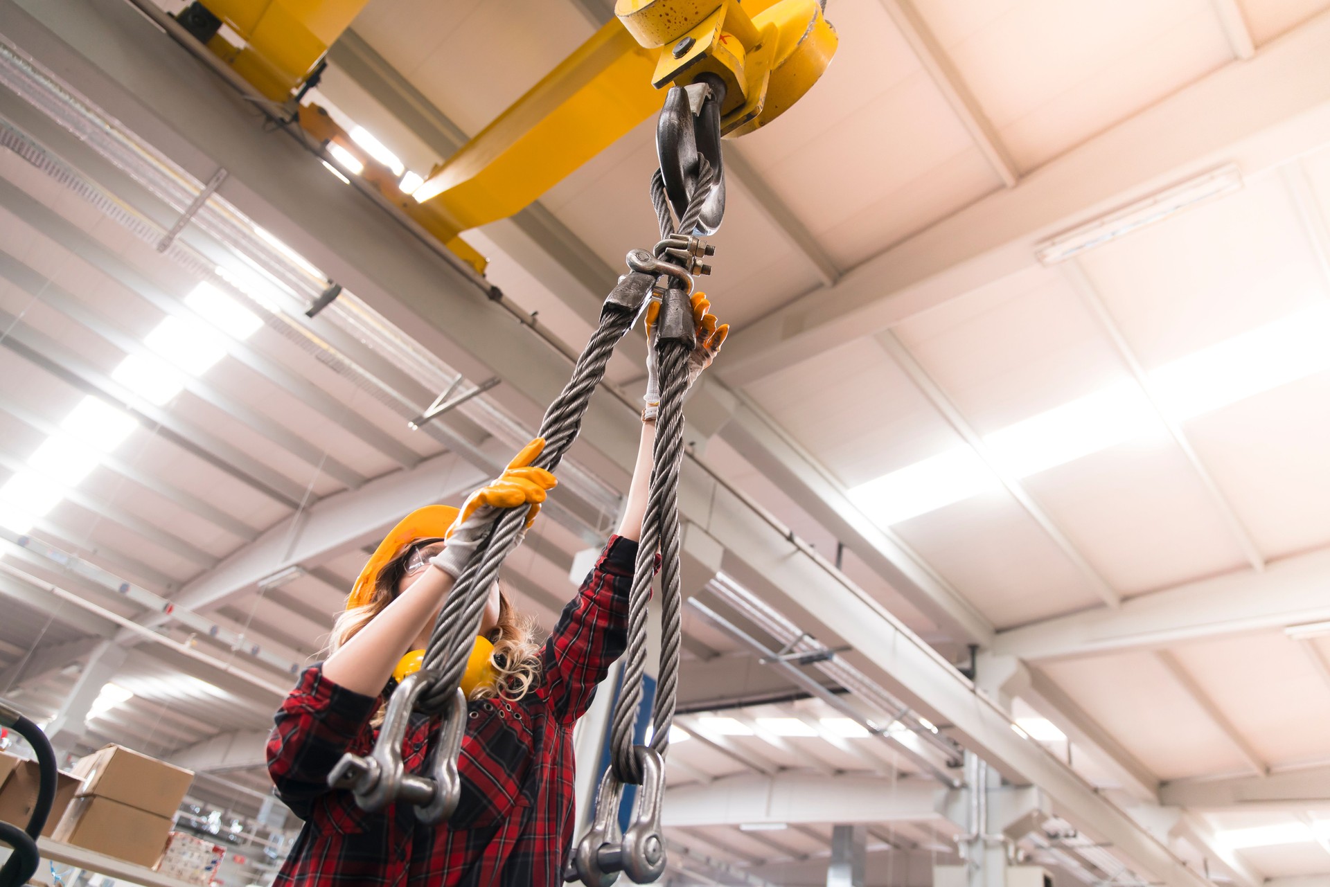 Young manual worker and working with cable winch